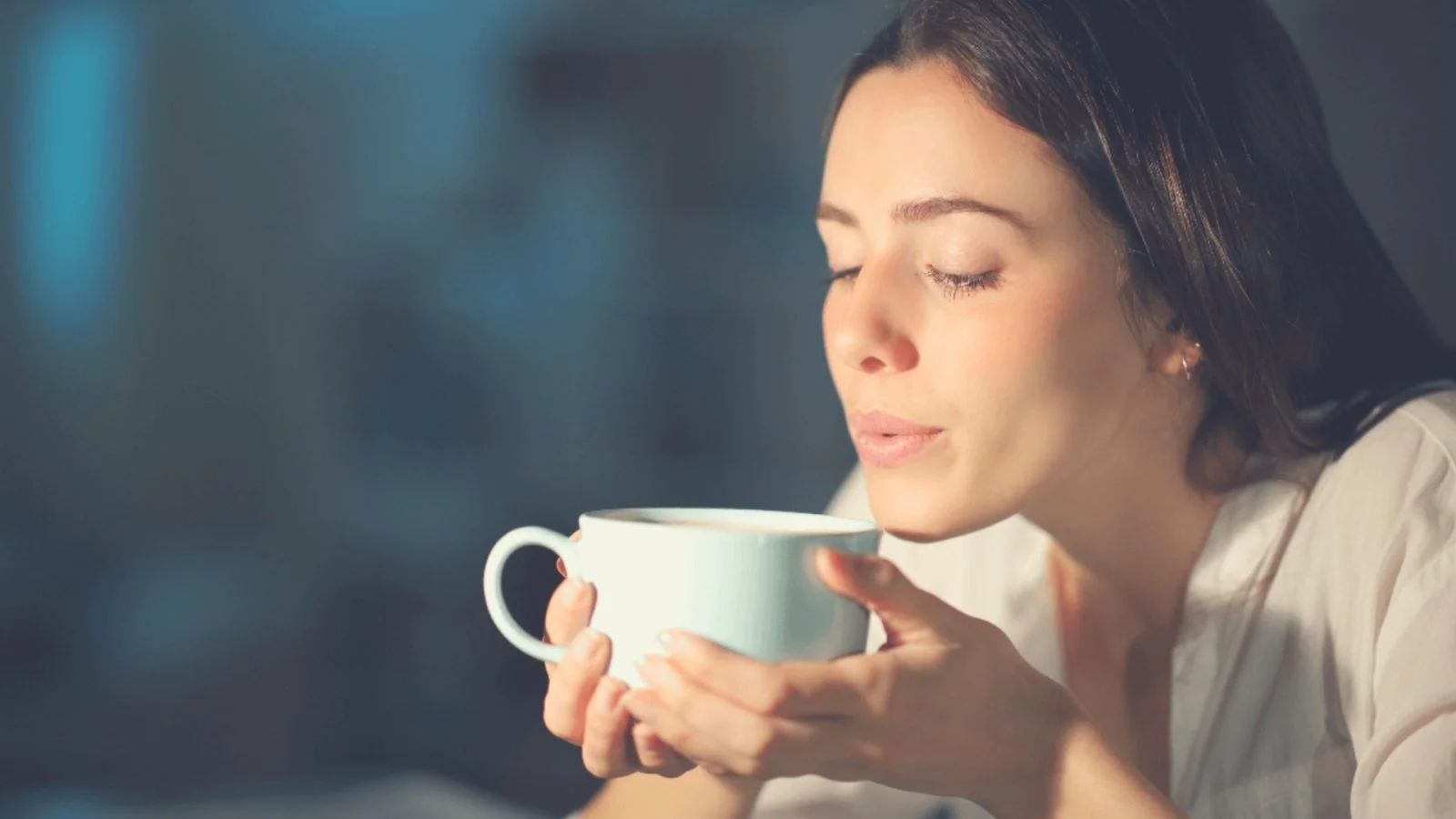 Woman blowing coffee