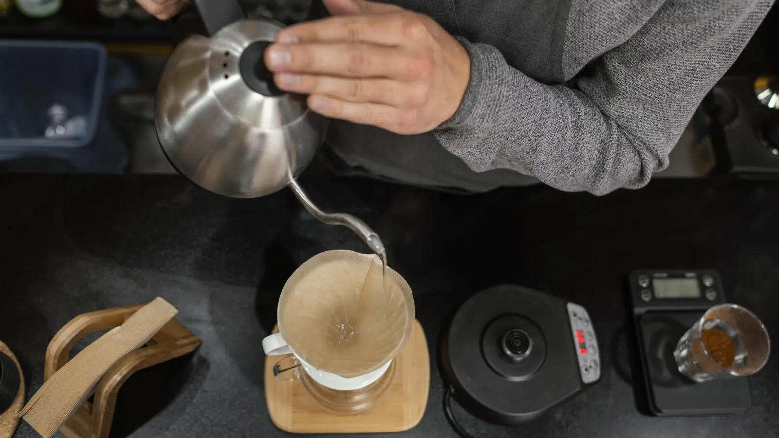 Male Barista Pouring Boiling Water to Coffee Filter